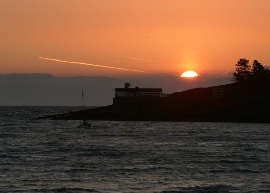 Sunrise behind the old lifeboat station near Abersoch